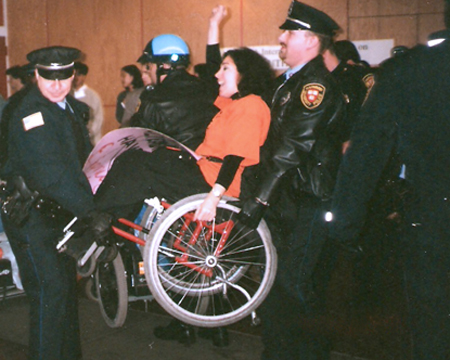 Nadina under arrest being carried away by police